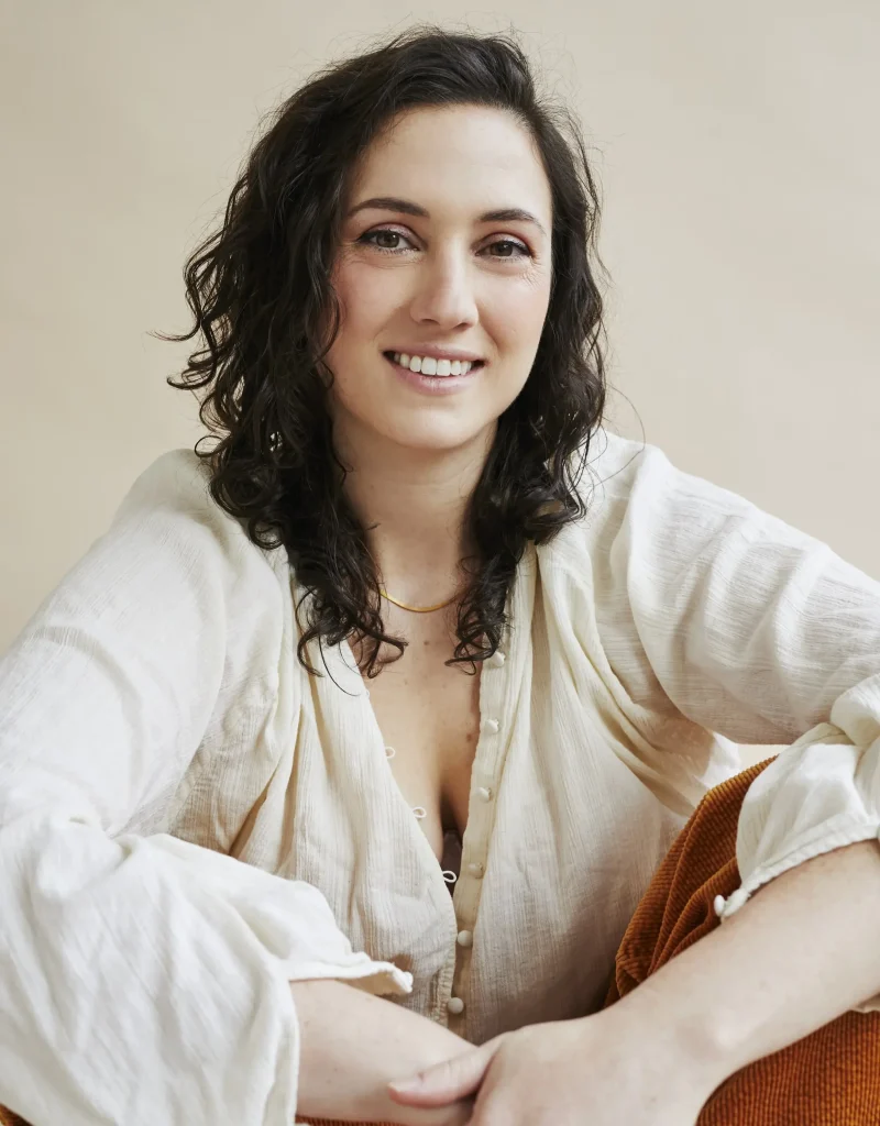 Casey Johnston, a smiling young white woman with long brown hair
