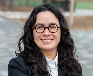 Claire Valdez smiles in a headshot