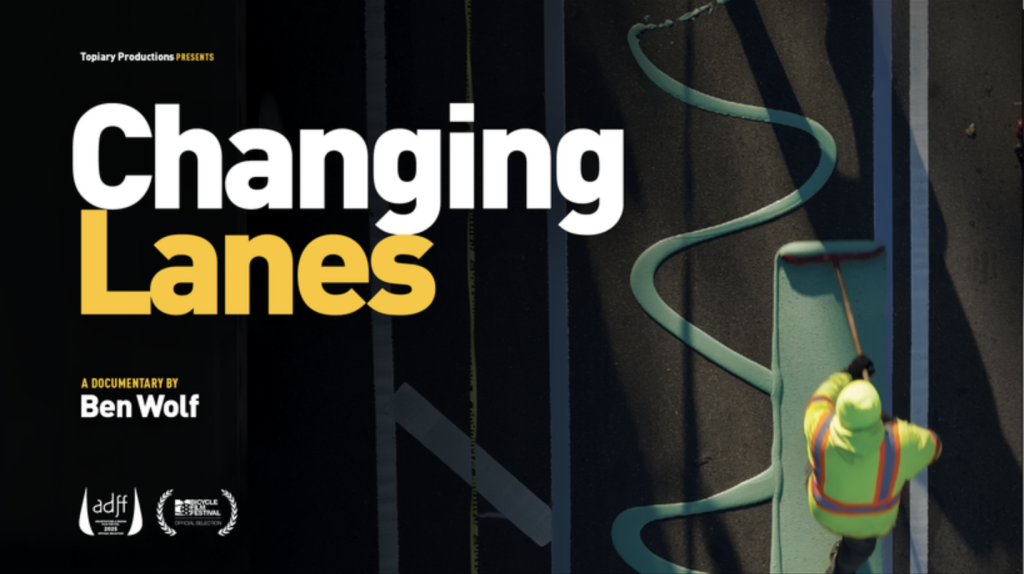 The promotional poster for the documentary Changing Lanes by Ben Wolf, illustrated by an overhead image of a worker in a high-viz vest rolling paint onto a street.